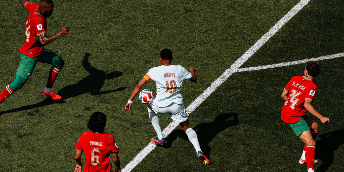 A player trying to dribble past othe players